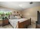 Comfortable main bedroom featuring tile floors, a window, and furnishings at 16318, 16250 & 16300 County Road 448, Mount Dora, FL 32757
