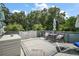 Relaxing outdoor deck features comfortable seating and is surrounded by mature trees at 16318, 16250 & 16300 County Road 448, Mount Dora, FL 32757