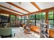 Bright sunroom featuring tile floors, wood beams, and large windows overlooking the lush backyard at 16318, 16250 & 16300 County Road 448, Mount Dora, FL 32757