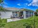 Backyard features a patio with grill, table set, and lush green lawn perfect for outdoor entertaining at 1675 Westminster Ct, The Villages, FL 32162
