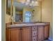 Bathroom with a double vanity and large mirror at 1675 Westminster Ct, The Villages, FL 32162