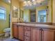Bathroom featuring a double vanity and large mirror at 1675 Westminster Ct, The Villages, FL 32162