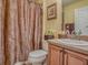 Bathroom featuring a single vanity, toilet, and shower with curtain at 1675 Westminster Ct, The Villages, FL 32162
