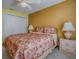 This bedroom has a ceiling fan, a closet, and two side tables at 1675 Westminster Ct, The Villages, FL 32162