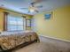 Neutral bedroom featuring carpet, a ceiling fan, and a window at 1675 Westminster Ct, The Villages, FL 32162