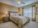 This bedroom has a dark wood bed frame, and a window at 1675 Westminster Ct, The Villages, FL 32162