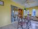 Bright dining area with a table set and large windows, seamlessly connecting the indoors with outdoor views at 1675 Westminster Ct, The Villages, FL 32162
