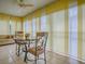 Bright dining area featuring stylish table set with ceiling fan, tile flooring, and sliding window at 1675 Westminster Ct, The Villages, FL 32162
