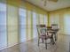 Bright dining area with tile floors, ceiling fan, and large windows with vertical blinds at 1675 Westminster Ct, The Villages, FL 32162