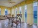 Dining area features a table and chairs, large windows offering outdoor views, and comfortable seating at 1675 Westminster Ct, The Villages, FL 32162
