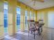 Bright dining area with a stylish table set and large windows providing ample natural light and views at 1675 Westminster Ct, The Villages, FL 32162