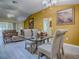 Bright dining room boasts wood floors and views into the living room at 1675 Westminster Ct, The Villages, FL 32162