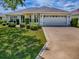 Charming single-story home with an attached garage, manicured landscaping, and a classic suburban appeal at 1675 Westminster Ct, The Villages, FL 32162