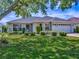 Charming single-story home featuring a well-manicured lawn and beautiful landscaping at 1675 Westminster Ct, The Villages, FL 32162
