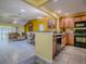 Open concept kitchen with wood cabinets and stainless steel dishwasher at 1675 Westminster Ct, The Villages, FL 32162