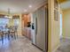 Kitchen with stainless steel refrigerator and adjacent breakfast nook at 1675 Westminster Ct, The Villages, FL 32162