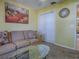 Cozy room with a comfortable sofa, carpet, and ample light from a large window at 1675 Westminster Ct, The Villages, FL 32162