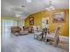 Open-concept living room featuring vaulted ceilings, and stylish furniture at 1675 Westminster Ct, The Villages, FL 32162