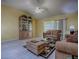 Inviting living room features wood floors and a large sliding glass door at 1675 Westminster Ct, The Villages, FL 32162