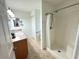 Bathroom featuring a sink, shower with white curtain and tile flooring at 17483 Se 74Th Netherclift Ter, The Villages, FL 32162
