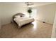 Neutral bedroom with tiled floor, ceiling fan and natural light from window at 17483 Se 74Th Netherclift Ter, The Villages, FL 32162