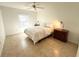 Bedroom with neutral colors, ceiling fan, tile flooring and bright natural light at 17483 Se 74Th Netherclift Ter, The Villages, FL 32162