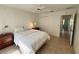 Bedroom showcasing tile flooring, ceiling fan, and open doorway at 17483 Se 74Th Netherclift Ter, The Villages, FL 32162