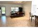 Open dining area features a dark wood table, tile floors, and direct access to the kitchen at 17483 Se 74Th Netherclift Ter, The Villages, FL 32162