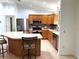Well-appointed kitchen with stainless steel appliances, a mosaic backsplash, and wooden cabinets at 17483 Se 74Th Netherclift Ter, The Villages, FL 32162