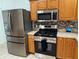 Modern kitchen featuring stainless steel appliances and lots of cabinet storage at 17483 Se 74Th Netherclift Ter, The Villages, FL 32162