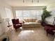 Cozy living room featuring comfortable seating, tiled floors, and lots of natural light at 17483 Se 74Th Netherclift Ter, The Villages, FL 32162