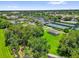 Aerial view showcasing Mulberry Grove's tennis courts, pool, shuffleboard, and meticulously maintained grounds at 17695 Se 84Th Peyton Ct, The Villages, FL 32162