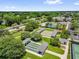 Aerial view of bocce and shuffleboard courts with well maintained green spaces and landscaping at 17695 Se 84Th Peyton Ct, The Villages, FL 32162