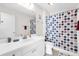 Bathroom with a sink, toilet, and shower with a colorful curtain at 17695 Se 84Th Peyton Ct, The Villages, FL 32162