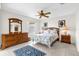 Cozy bedroom with a ceiling fan, tile flooring, and a large dresser at 17695 Se 84Th Peyton Ct, The Villages, FL 32162