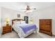 Bedroom with a ceiling fan, tile floors, a bed, and dresser at 17695 Se 84Th Peyton Ct, The Villages, FL 32162