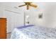 Bedroom featuring a ceiling fan, closet, and tile flooring at 17695 Se 84Th Peyton Ct, The Villages, FL 32162