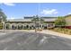 Mulberry Grove recreation center features a covered entry, white pillars and ample parking at 17695 Se 84Th Peyton Ct, The Villages, FL 32162
