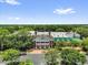 Overhead view of the community center, surrounded by a lush landscape, adjacent to a parking lot at 17695 Se 84Th Peyton Ct, The Villages, FL 32162