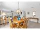 Warm dining area with a wooden table and chairs, flowing into the living room with comfortable seating at 17695 Se 84Th Peyton Ct, The Villages, FL 32162