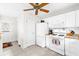 Functional kitchen with white cabinets, appliances, and tiled floor, offering ample space for cooking and storage at 17695 Se 84Th Peyton Ct, The Villages, FL 32162