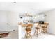 Kitchen with breakfast bar and pendant lighting, seamlessly connected to the dining area and additional space at 17695 Se 84Th Peyton Ct, The Villages, FL 32162