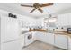 Bright kitchen featuring white appliances, wooden countertops, and a window over the sink at 17695 Se 84Th Peyton Ct, The Villages, FL 32162