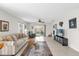 Bright living room featuring a ceiling fan, tile flooring, and sliding glass doors to the backyard at 17695 Se 84Th Peyton Ct, The Villages, FL 32162