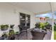 Cozy covered patio with outdoor seating and sliding glass door access to the home's interior at 17695 Se 84Th Peyton Ct, The Villages, FL 32162