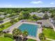 Aerial view of outdoor community swimming pool with mature landscaping and surrounding neighborhood at 17695 Se 84Th Peyton Ct, The Villages, FL 32162
