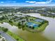 Beautiful aerial view of a residential community with lakes and tennis courts at 1990 Wallingford Loop, Mount Dora, FL 32757