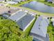 Aerial view of neighborhood homes backing up to community pond at 1990 Wallingford Loop, Mount Dora, FL 32757