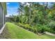 Lush backyard with well-maintained lawn and garden beds at 1990 Wallingford Loop, Mount Dora, FL 32757
