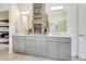 Bright bathroom featuring double vanity, ample storage, and modern fixtures at 1990 Wallingford Loop, Mount Dora, FL 32757
